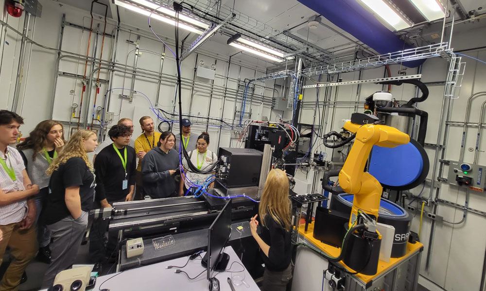 NCSS students tour a beamline station with a robotic sample changer