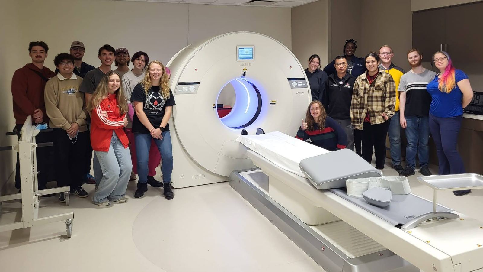 NCSS students pose with a medical CT scanner at Stony Brook University